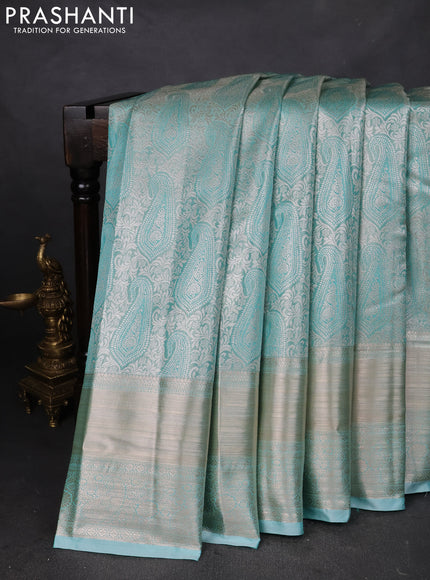 Semi kanchipuram tissue silk saree teal blue with allover silver zari woven brocade weaves and long zari woven border