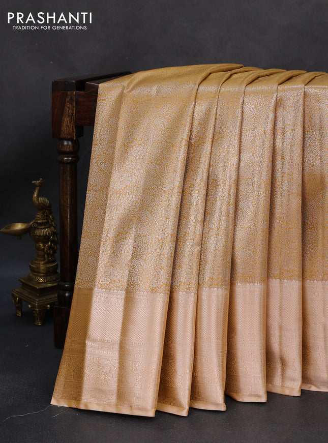 Semi kanchipuram tissue silk saree mustard yellow with allover silver zari woven brocade weaves and long zari woven border