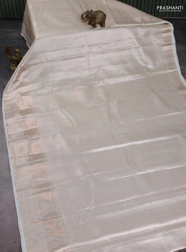 Semi kanchipuram tissue silk saree cream with allover silver zari woven brocade weaves and long zari woven border