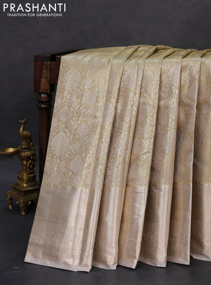 Semi kanchipuram tissue silk saree beige and pastel grey with allover silver zari woven brocade weaves and long zari woven border