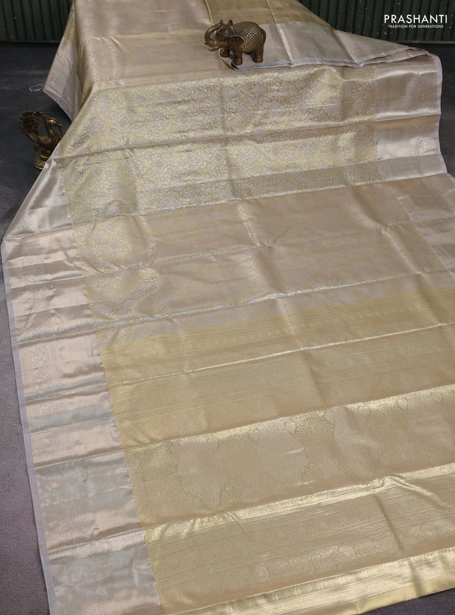Semi kanchipuram tissue silk saree beige and pastel grey with allover silver zari woven brocade weaves and long zari woven border