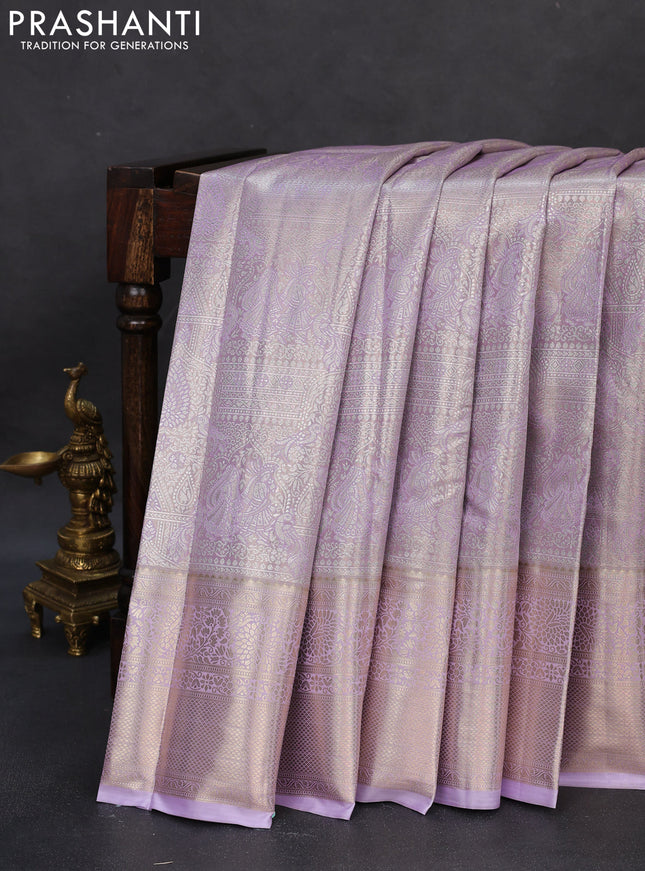 Semi kanchipuram tissue silk saree mild lavender with allover silver zari woven brocade weaves and long zari woven border