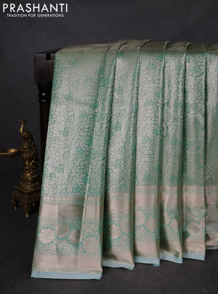 Semi kanchipuram tissue silk saree green shade with allover silver zari woven brocade weaves and zari woven border