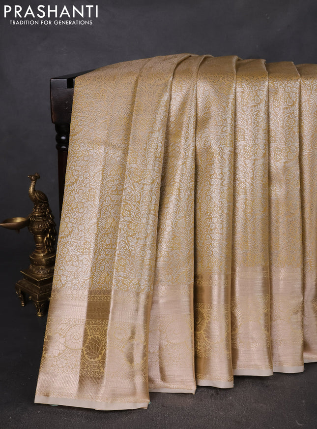 Semi kanchipuram tissue silk saree sandal with allover silver zari woven brocade weaves and zari woven border