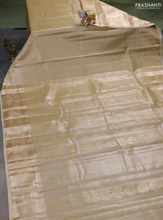 Semi kanchipuram tissue silk saree sandal with allover silver zari woven brocade weaves and zari woven border