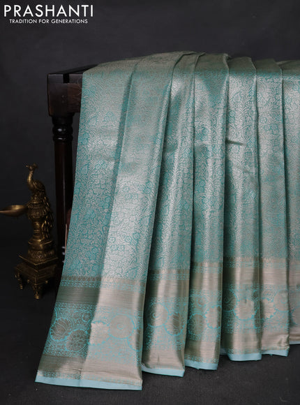 Semi kanchipuram tissue silk saree teal shade with allover silver zari woven brocade weaves and zari woven border