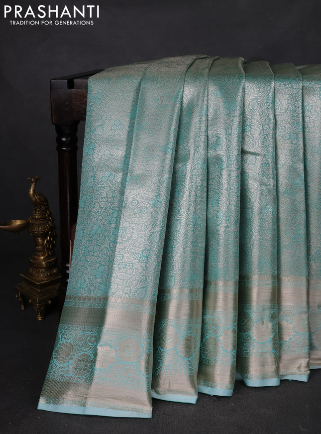 Semi kanchipuram tissue silk saree teal shade with allover silver zari woven brocade weaves and zari woven border