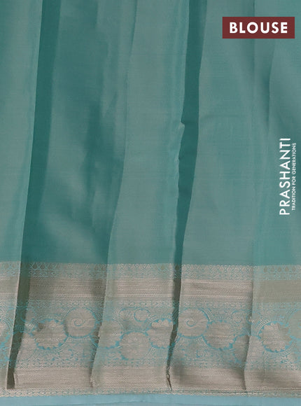 Semi kanchipuram tissue silk saree teal shade with allover silver zari woven brocade weaves and zari woven border