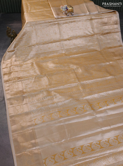 Semi kanchipuram tissue silk saree sandal with allover silver zari woven brocade weaves and zari woven border