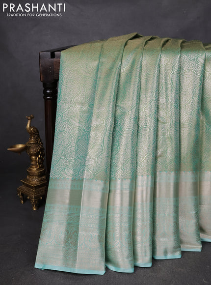 Semi kanchipuram tissue silk saree teal shade with allover silver zari woven brocade weaves and long zari woven border
