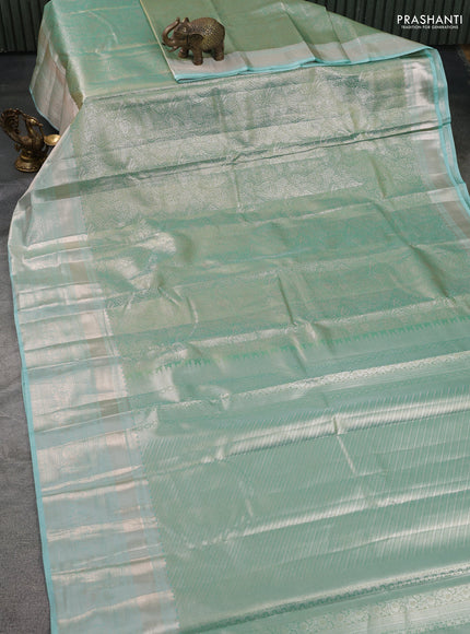 Semi kanchipuram tissue silk saree teal shade with allover silver zari woven brocade weaves and long zari woven border