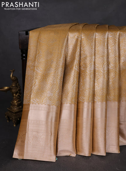 Semi kanchipuram tissue silk saree mustard yellow shade and sandal with allover silver zari woven brocade weaves and long zari woven border