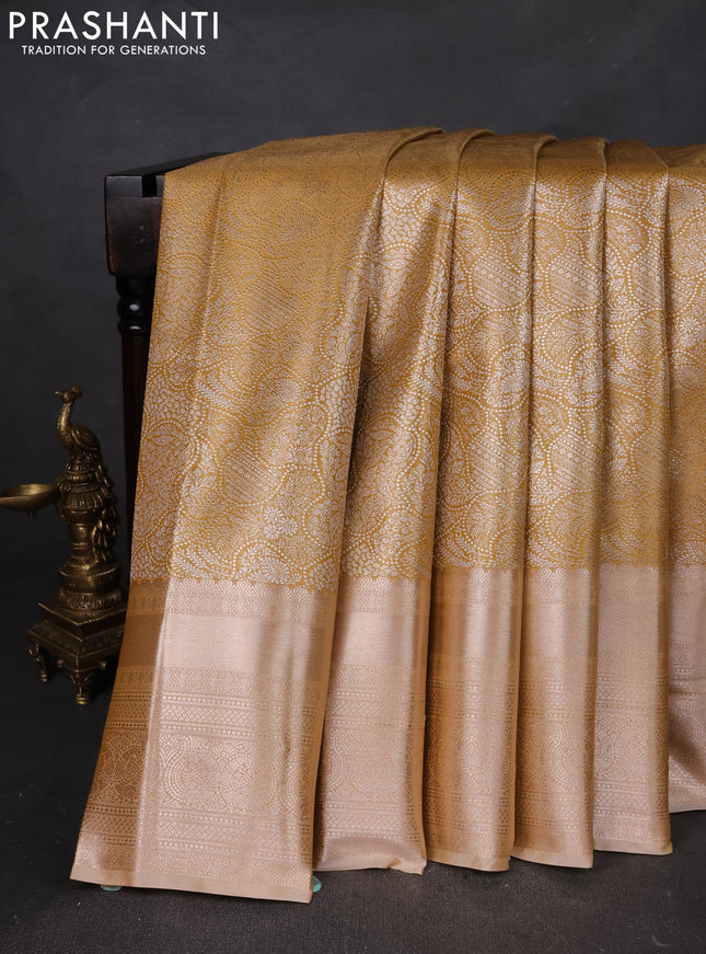 Semi kanchipuram tissue silk saree mustard yellow shade and sandal with allover silver zari woven brocade weaves and long zari woven border