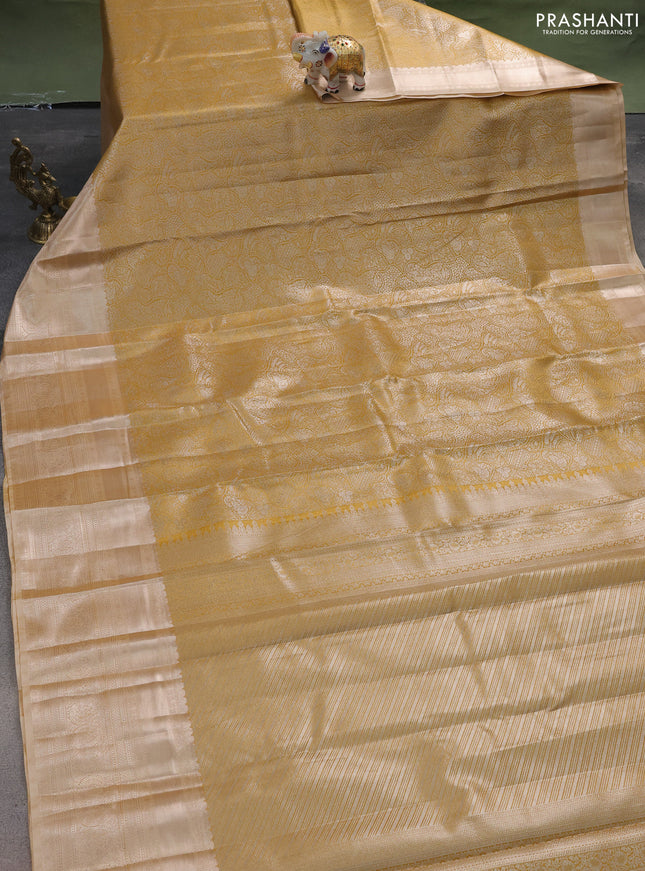 Semi kanchipuram tissue silk saree mustard yellow shade and sandal with allover silver zari woven brocade weaves and long zari woven border