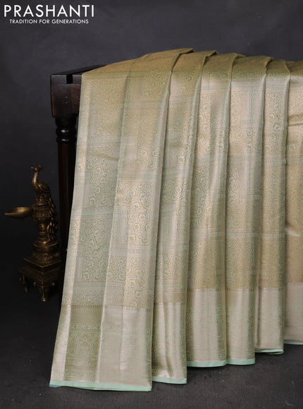 Semi kanchipuram tissue silk saree pista green with allover silver zari woven brocade weaves and zari woven border