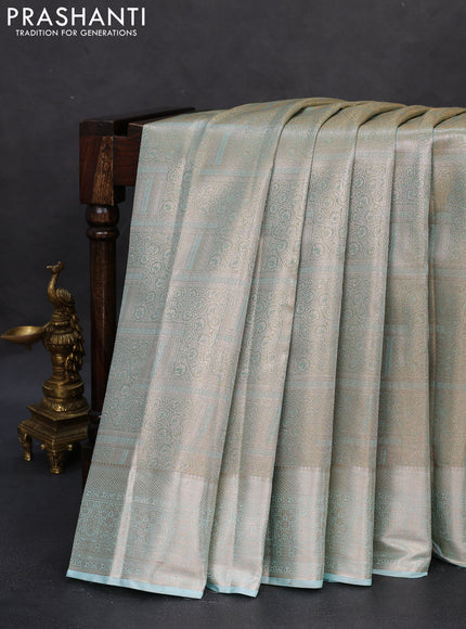 Semi kanchipuram tissue silk saree pastel blue shade and teal with allover silver zari woven brocade weaves and zari woven border