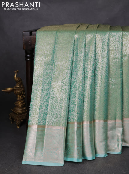 Semi kanchipuram tissue silk saree dual shade of teal green with allover silver zari woven brocade weaves and zari woven border