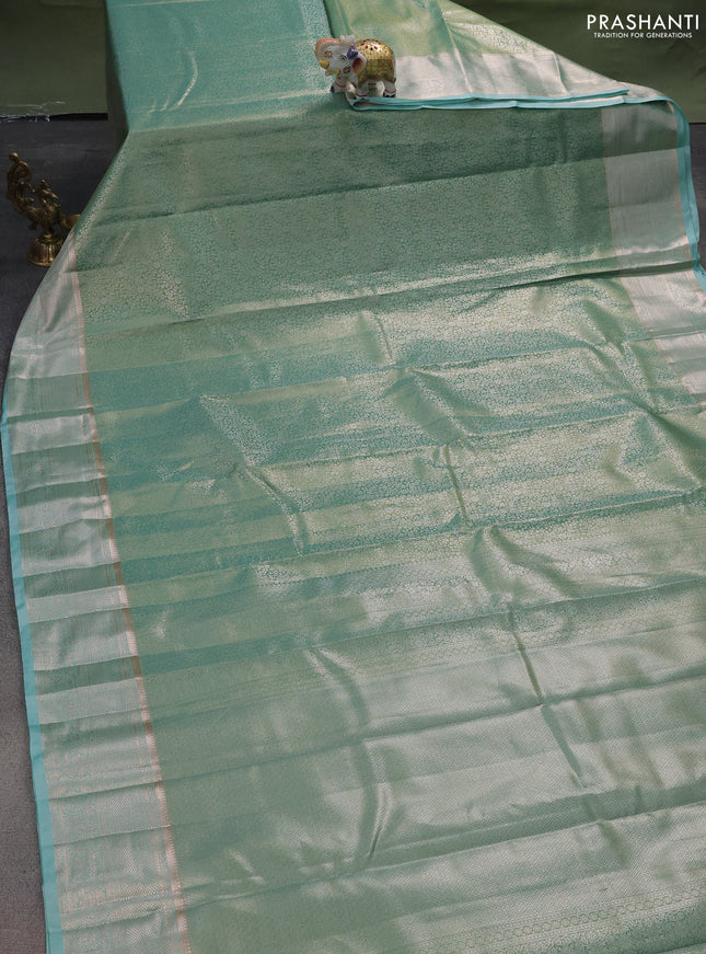 Semi kanchipuram tissue silk saree dual shade of teal green with allover silver zari woven brocade weaves and zari woven border