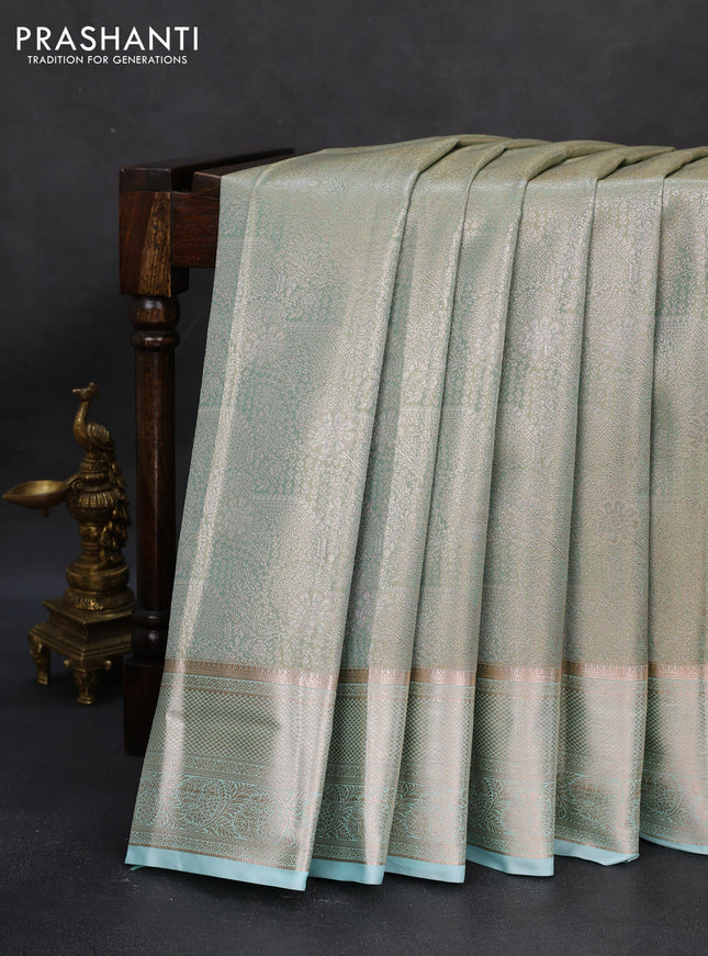 Semi kanchipuram tissue silk saree dual shade of teal blue with allover silver zari woven brocade weaves and zari woven border