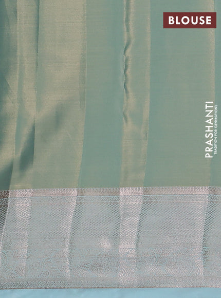 Semi kanchipuram tissue silk saree dual shade of teal blue with allover silver zari woven brocade weaves and zari woven border