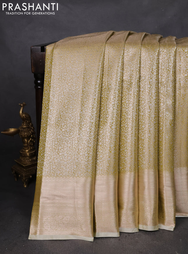 Semi kanchipuram tissue silk saree lime yellow with allover silver zari woven brocade weaves and zari woven border