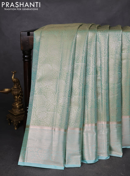 Semi kanchipuram tissue silk saree teal blue with allover silver zari woven brocade weaves and zari woven border