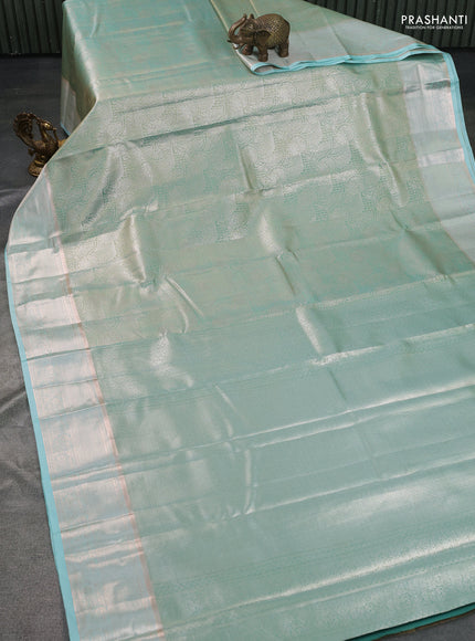 Semi kanchipuram tissue silk saree teal blue with allover silver zari woven brocade weaves and zari woven border