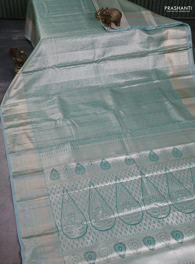Semi kanchipuram tissue silk saree teal shade with allover silver zari woven brocade weaves and zari woven border