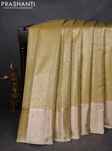 Semi kanchipuram tissue silk saree lime yellow with allover silver zari woven brocade weaves and zari woven border