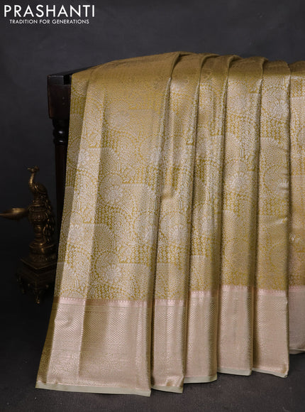 Semi kanchipuram tissue silk saree lime green with allover silver zari woven brocade weaves and zari woven border