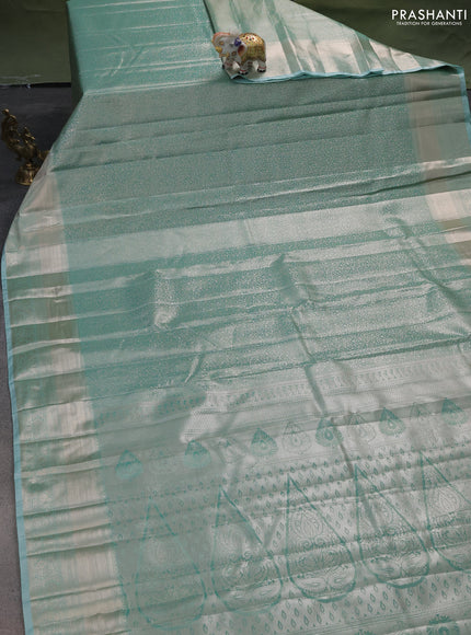 Semi kanchipuram tissue silk saree teal shade with allover silver zari woven brocade weaves and zari woven border