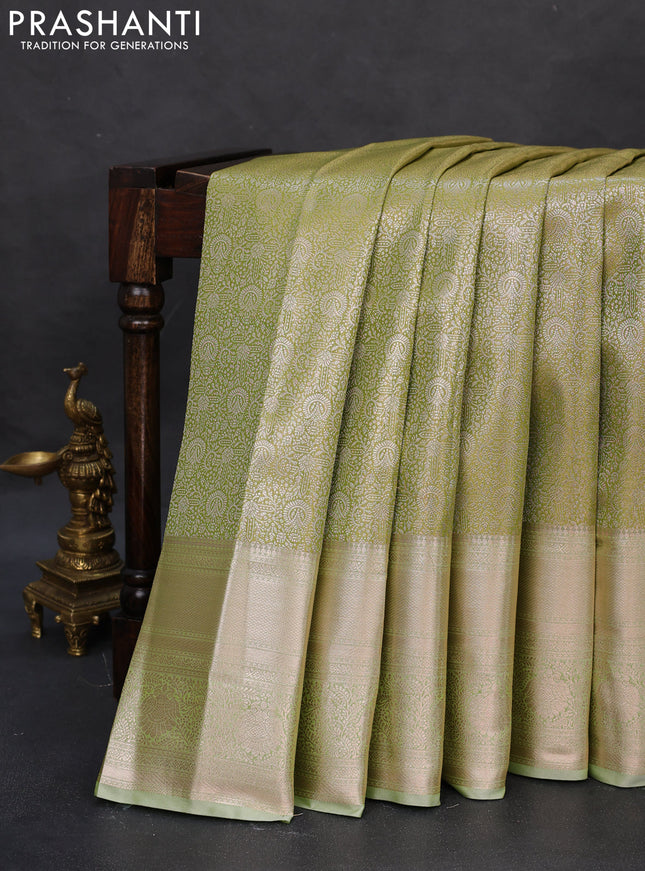 Semi kanchipuram tissue silk saree pista green with allover silver zari woven brocade weaves and long zari woven border
