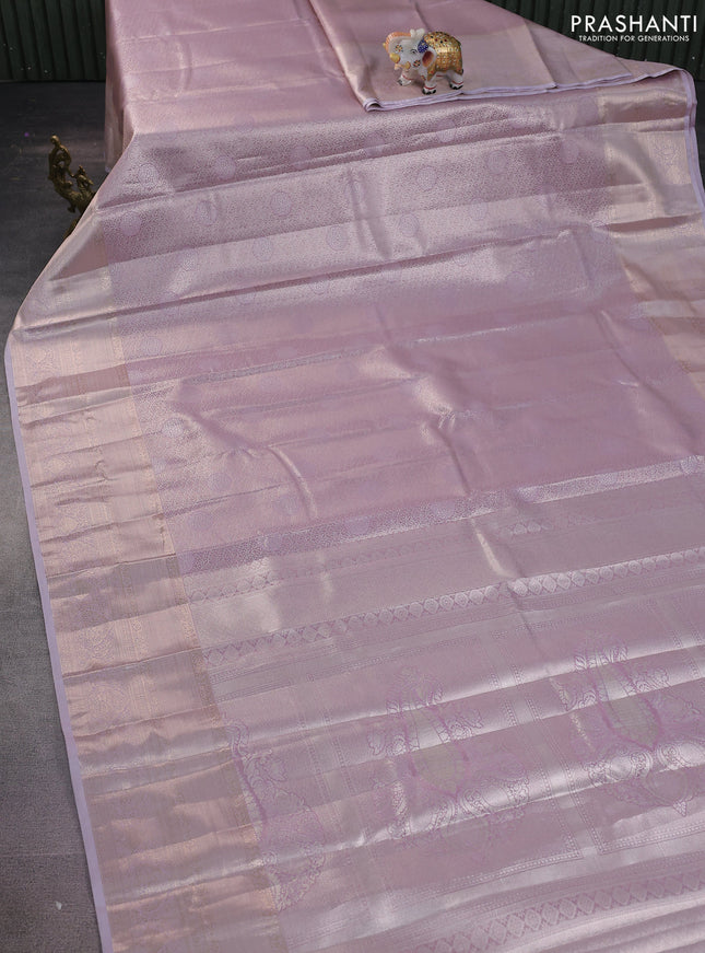 Semi kanchipuram tissue silk saree mild lavender with allover silver zari woven brocade weaves and long zari woven border