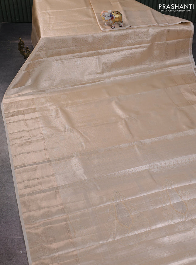 Semi kanchipuram tissue silk saree sandal with allover silver zari woven brocade weaves and long zari woven border