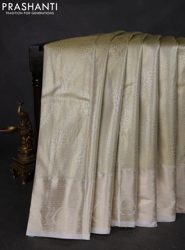 Semi kanchipuram tissue silk saree cream with allover silver zari woven brocade weaves and zari woven border