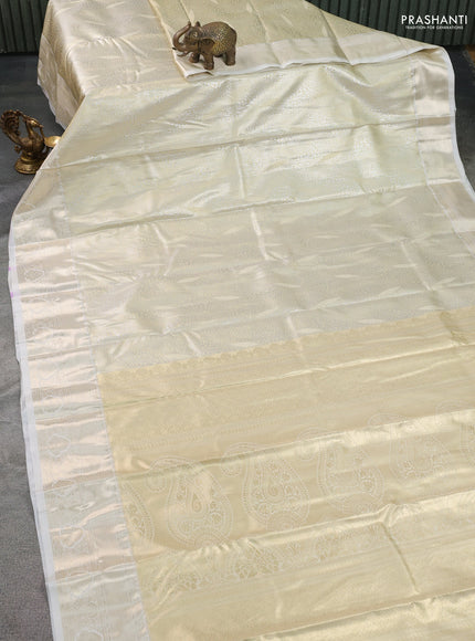 Semi kanchipuram tissue silk saree cream with allover silver zari woven brocade weaves and zari woven border