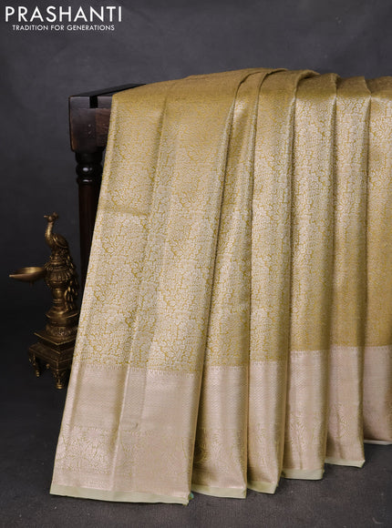Semi kanchipuram tissue silk saree lime green and elaichi green with allover silver zari woven brocade weaves and zari woven border
