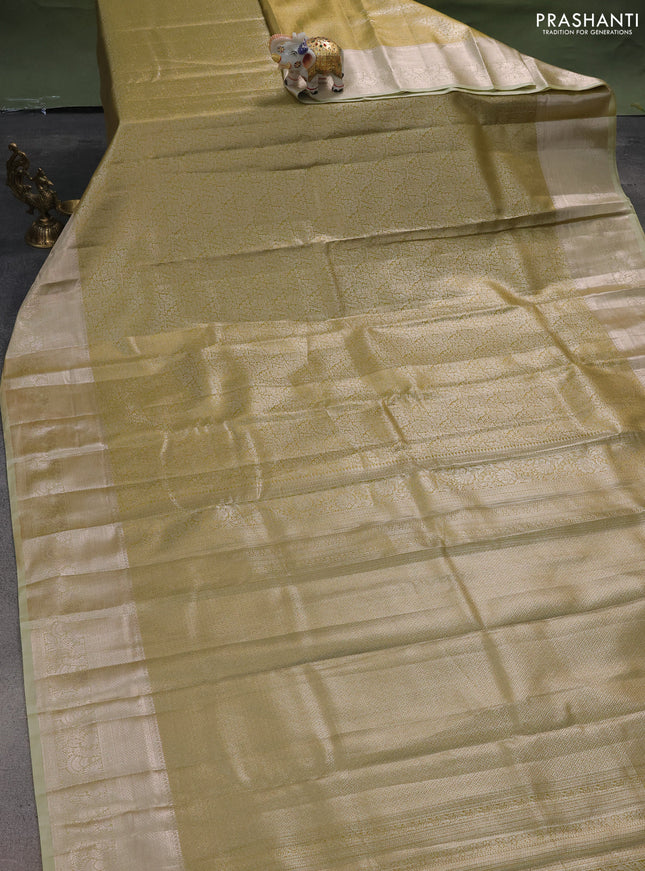 Semi kanchipuram tissue silk saree lime green and elaichi green with allover silver zari woven brocade weaves and zari woven border