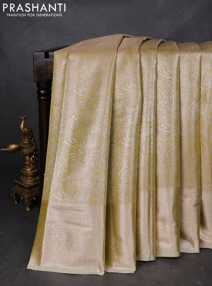 Semi kanchipuram tissue silk saree lime yellow with allover silver zari woven brocade weaves and zari woven border