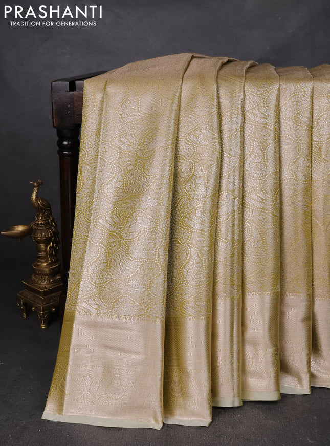 Semi kanchipuram tissue silk saree lime yellow with allover silver zari woven brocade weaves and zari woven border