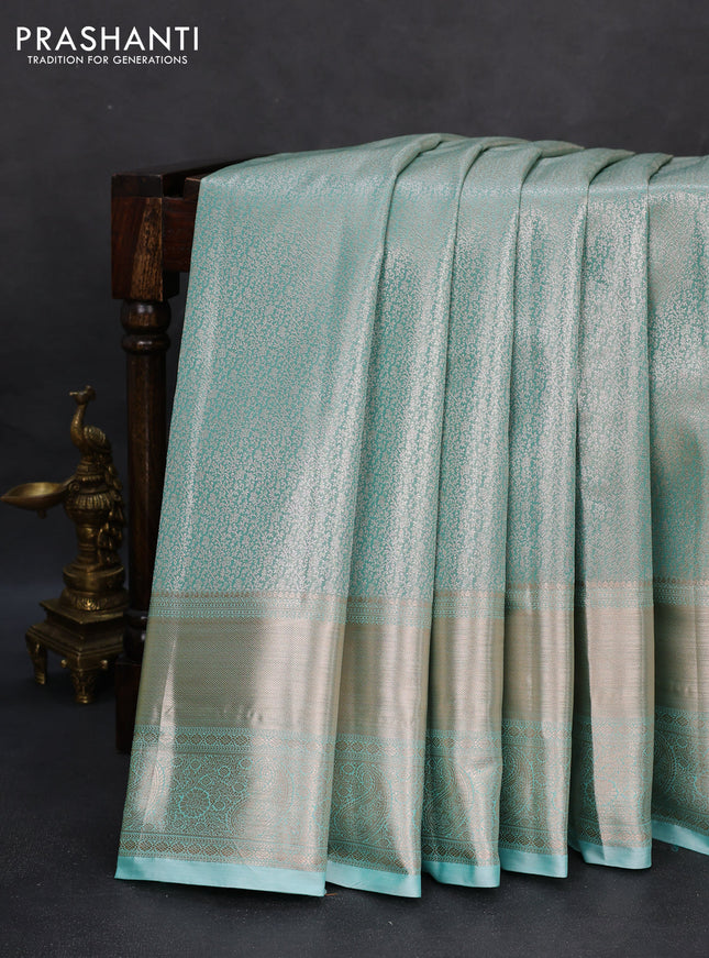 Semi kanchipuram tissue silk saree teal with allover silver zari woven brocade weaves and long zari woven border
