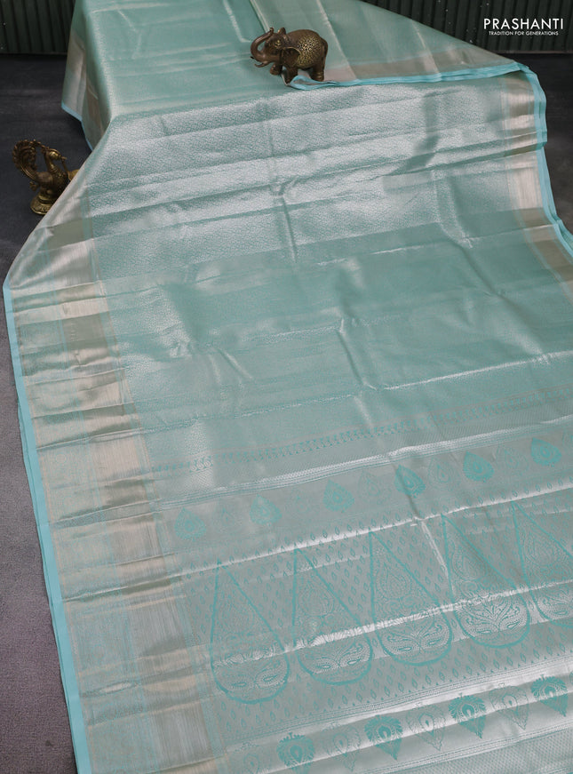Semi kanchipuram tissue silk saree teal with allover silver zari woven brocade weaves and long zari woven border