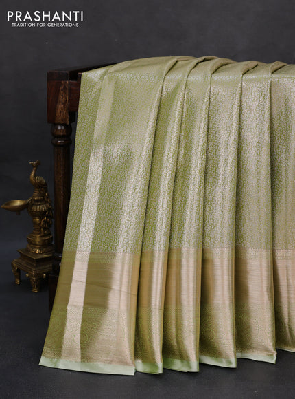 Semi kanchipuram tissue silk saree pista green with allover silver zari woven brocade weaves and long zari woven border