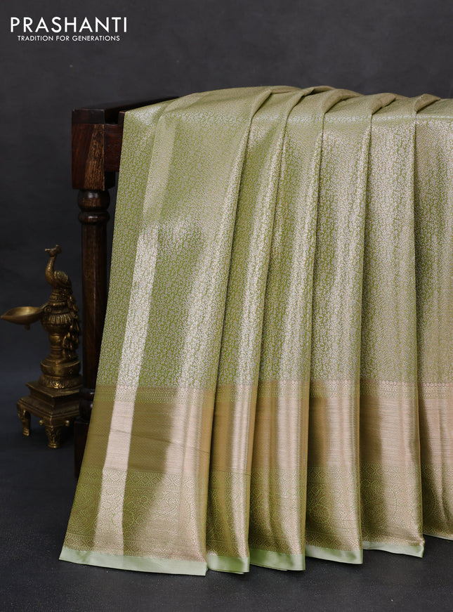 Semi kanchipuram tissue silk saree pista green with allover silver zari woven brocade weaves and long zari woven border