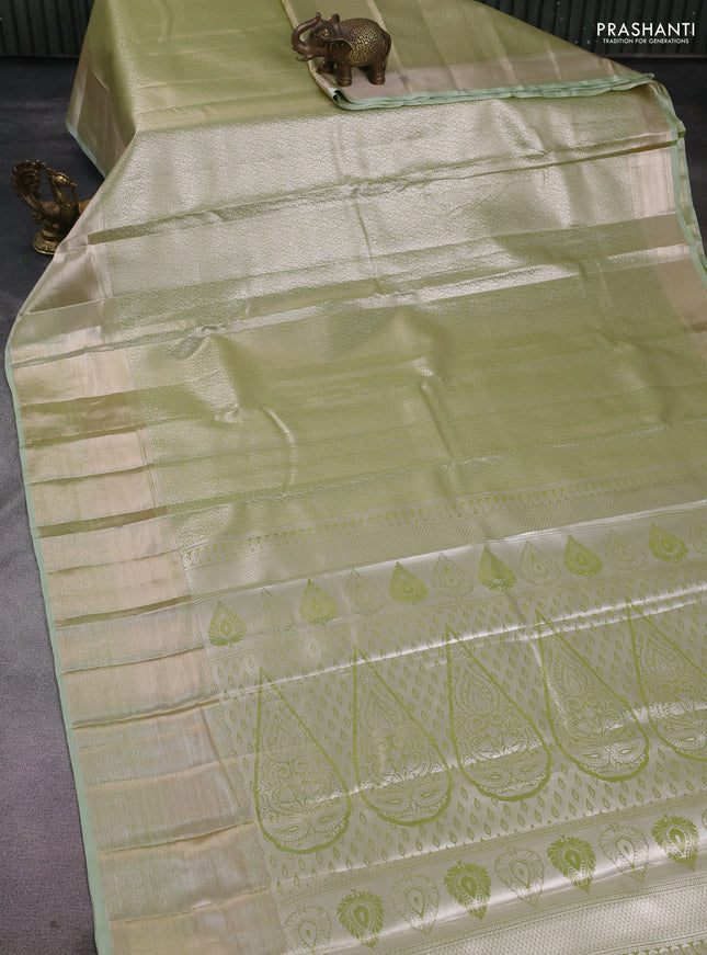 Semi kanchipuram tissue silk saree pista green with allover silver zari woven brocade weaves and long zari woven border