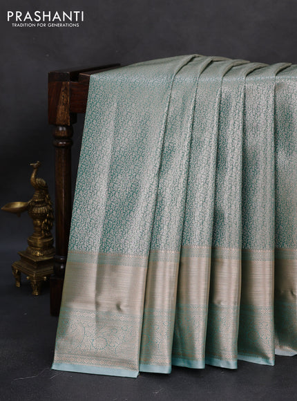 Semi kanchipuram tissue silk saree teal blue with allover silver zari woven brocade weaves and long zari woven border