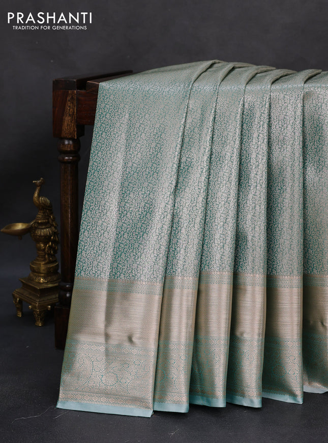 Semi kanchipuram tissue silk saree teal blue with allover silver zari woven brocade weaves and long zari woven border