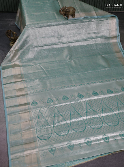 Semi kanchipuram tissue silk saree teal blue with allover silver zari woven brocade weaves and long zari woven border