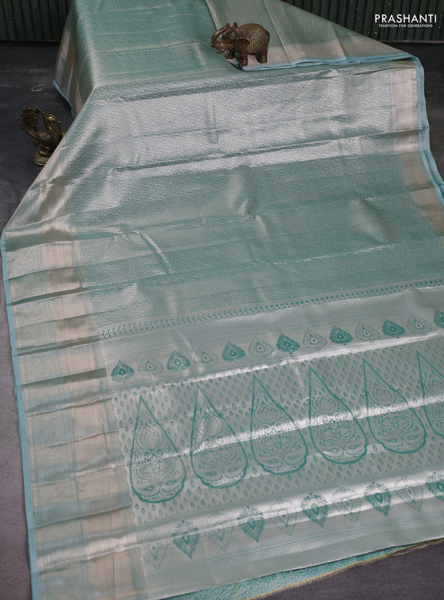 Semi kanchipuram tissue silk saree teal blue with allover silver zari woven brocade weaves and long zari woven border