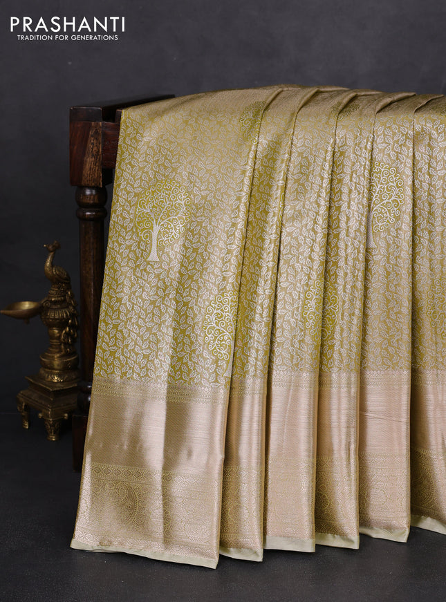 Semi kanchipuram tissue silk saree lime green and elaichi green with allover silver zari woven brocade weaves and long zari woven border